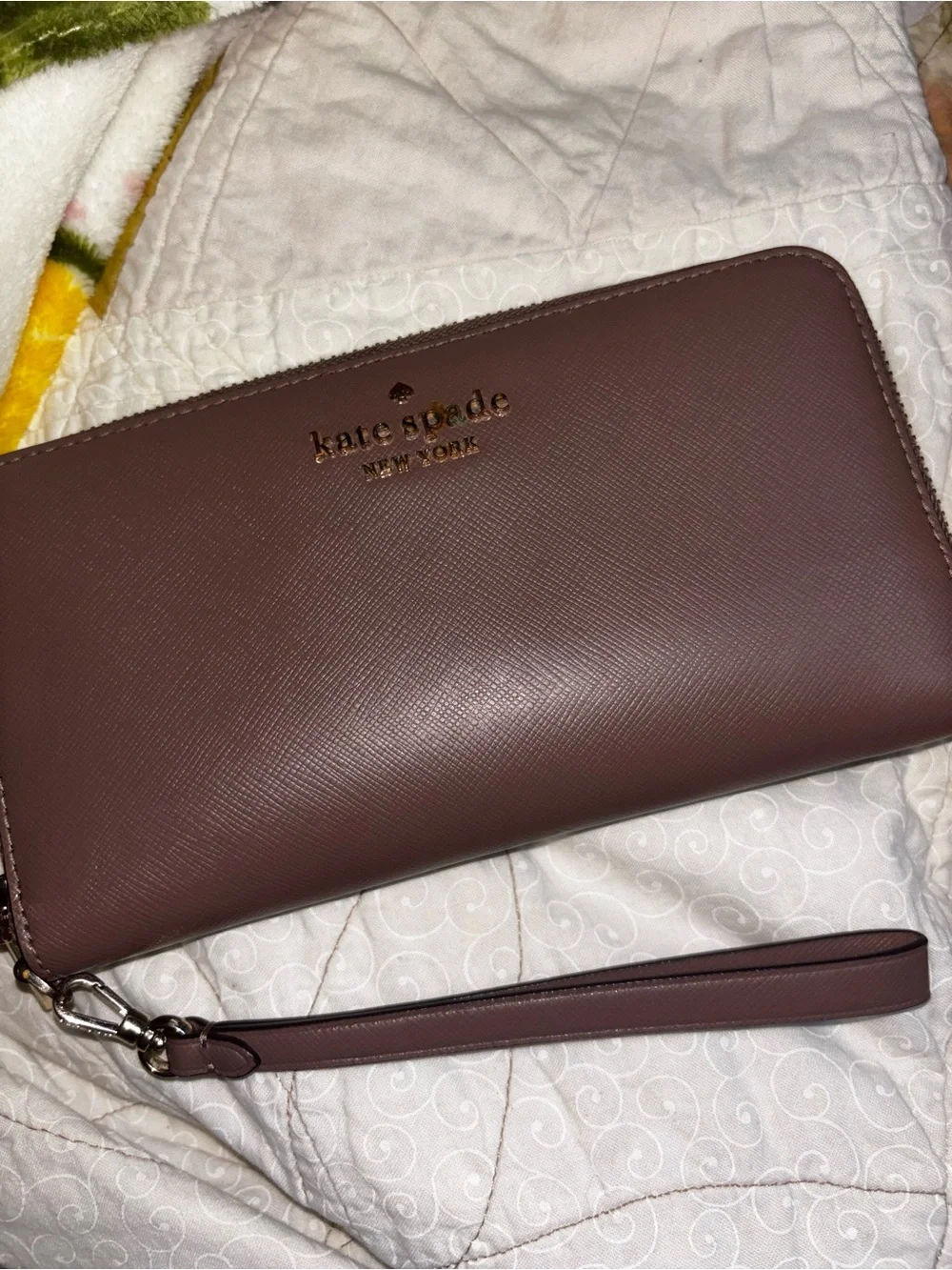 kate spade mauve zip-around wristlet with gold logo